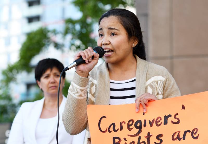 Former caregiver Hessed Torres speaks at a rally to mark International Domestic Workers Day on June 16, 2016.
